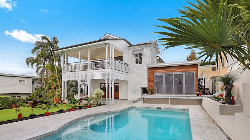 Couple hugging with house in background