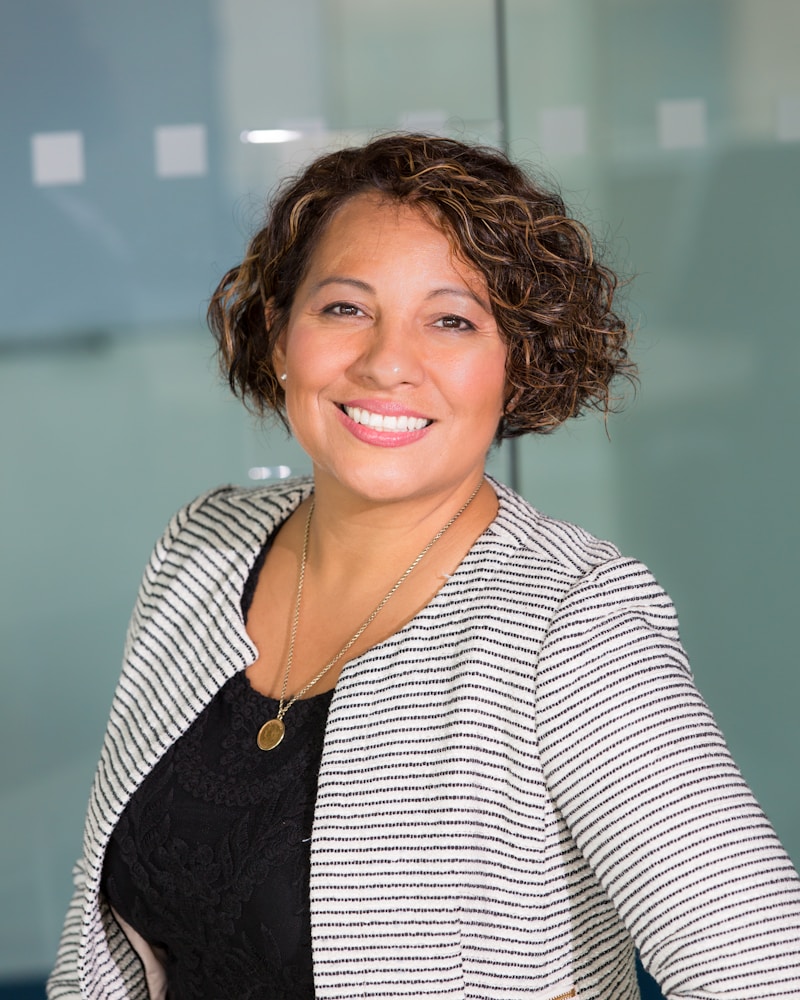 Woman sitting at a desk in front of her computer in her workshop.